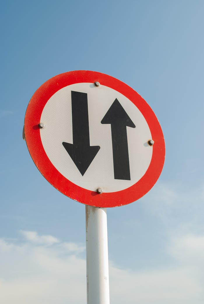 Two Way Traffic Sign Under Blue Sky